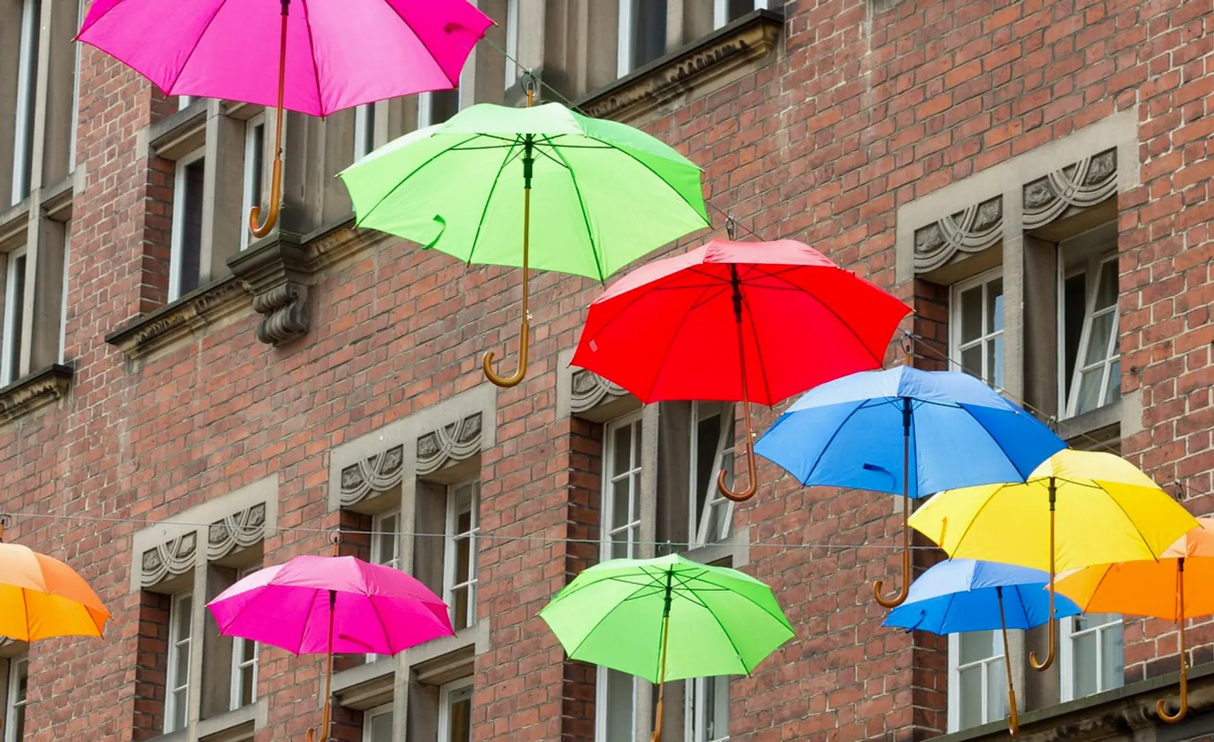 Umbrellas, house and wall